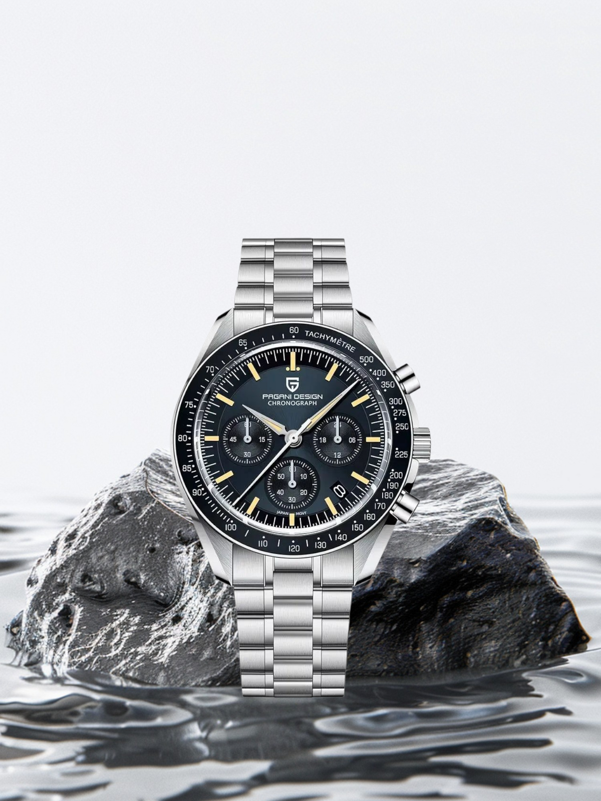 Silver watch with a black face on a rock in water