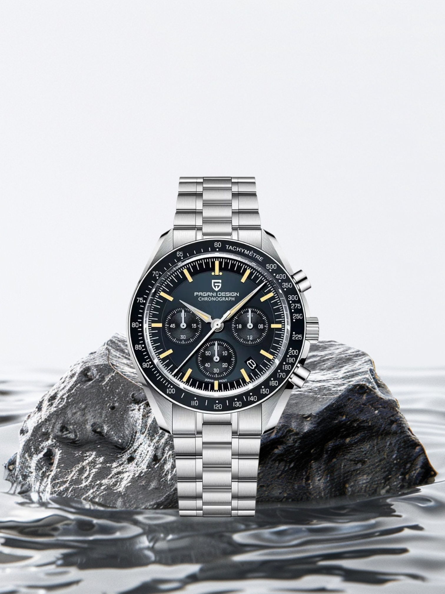 Silver watch with a black face on a rock in water